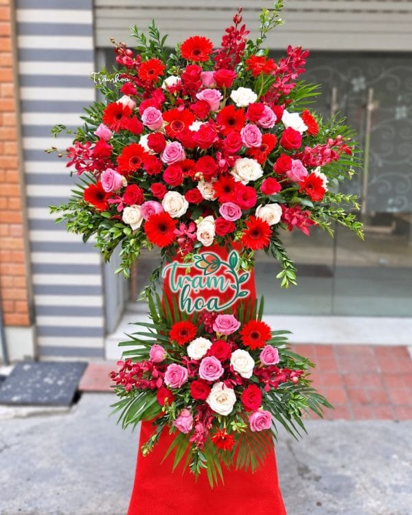 Kệ hoa Hồng Phát KT083 với đồng tiền đỏ, hồng đỏ,kem, hồng và các nhánh lan đỏ
